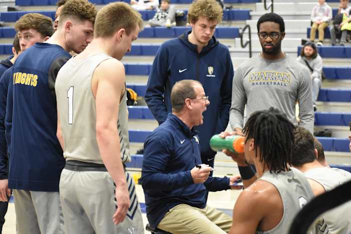 Marian basketball coach Scott Heady coaches his team during a timeout.